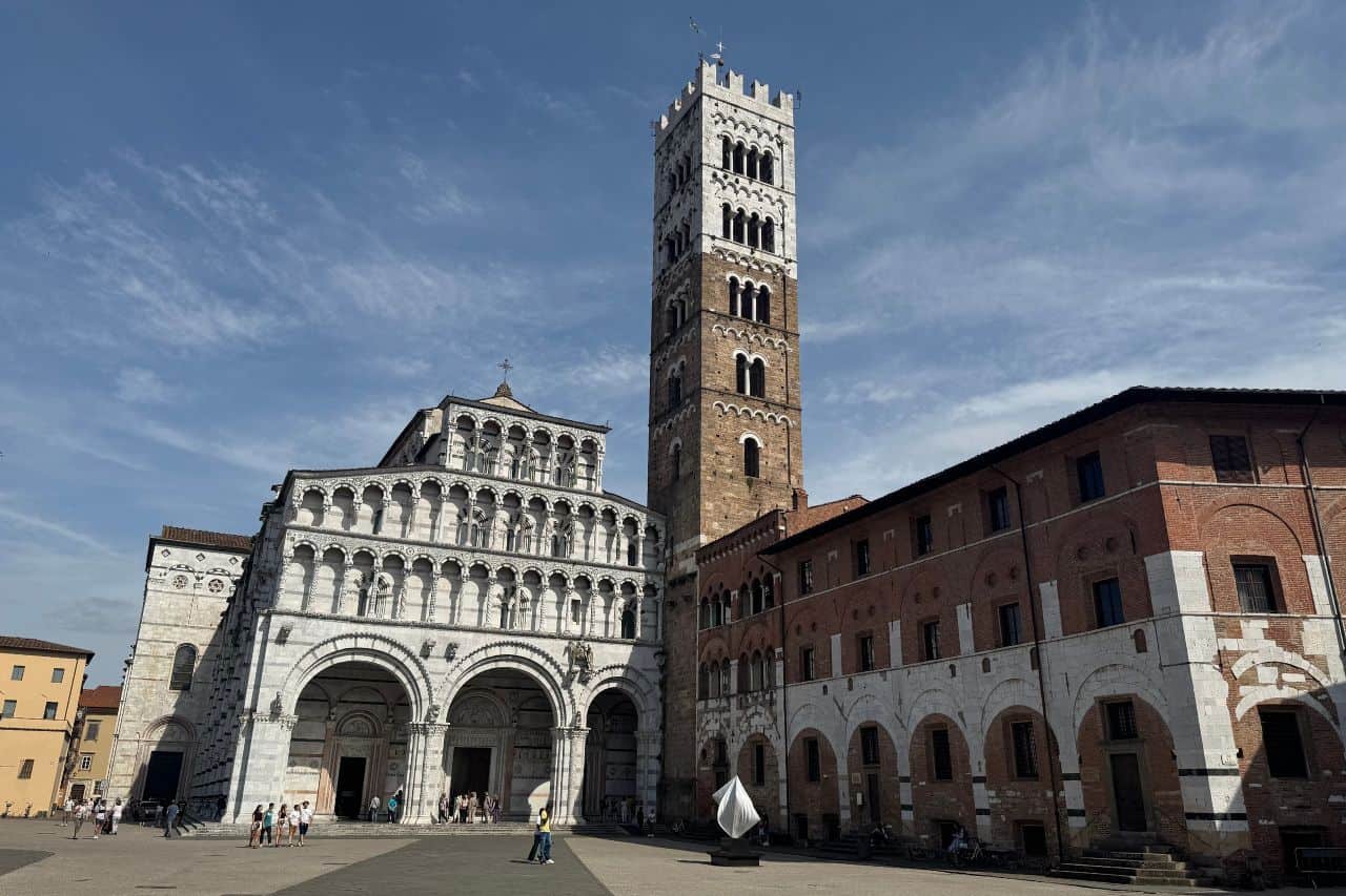 Historic Tower and Church Exterior in Lucca Italy Tower and church exterior set against a blue sky in the historic center of Lucca Italy