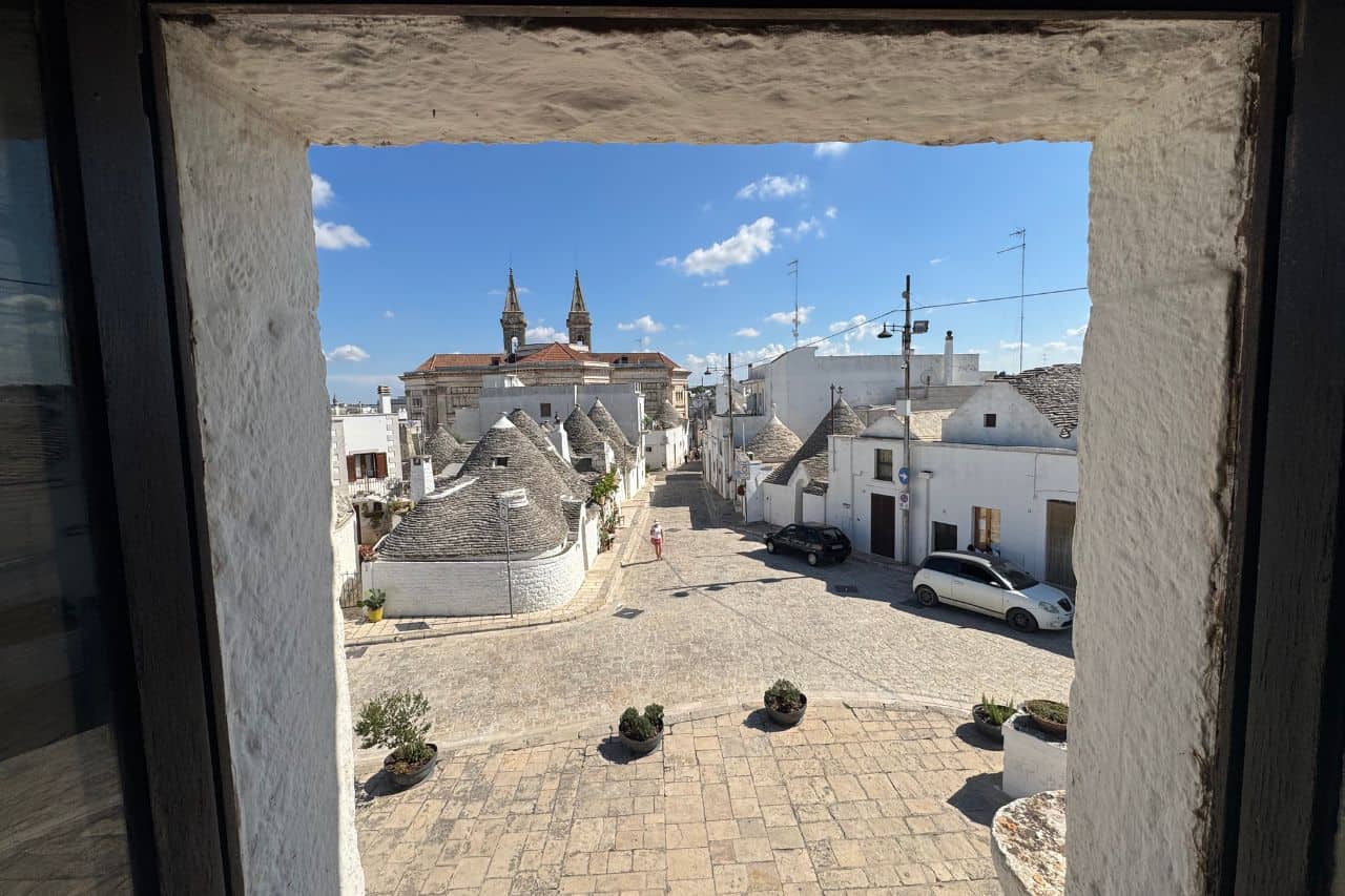 Cluster of Trulli Houses in Alberobello Cluster of traditional cone-roofed Trulli houses in Alberobello under a clear blue sky