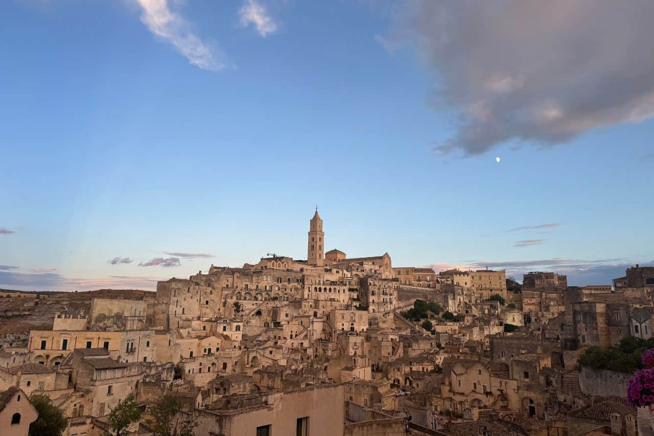 Traditional stone buildings in Matera’s Sassi district under a clear blue sky