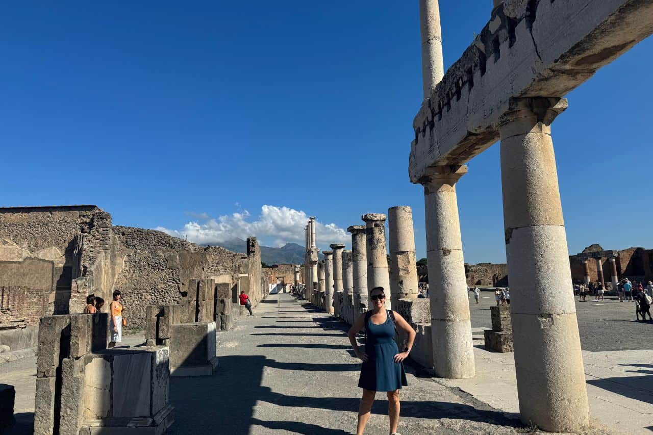 Exploring Pompeii ruins with ancient columns Person standing among ancient columns at the archaeological site of Pompeii, Italy
