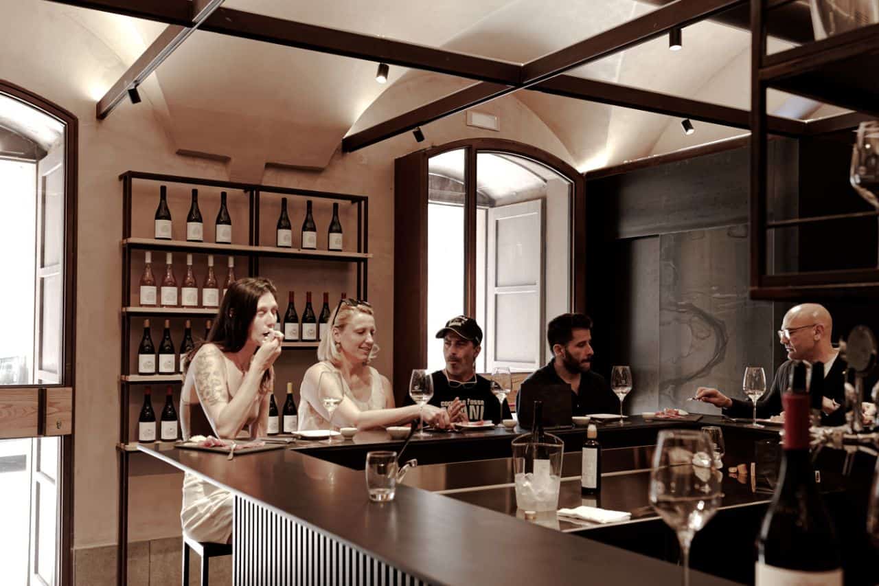 Wine Bar Catania at Tenute dei Ciclopi Visitors enjoying a guided wine tasting at Tenute dei Ciclopi, a wine bar and tasting room in Catania, Sicily.