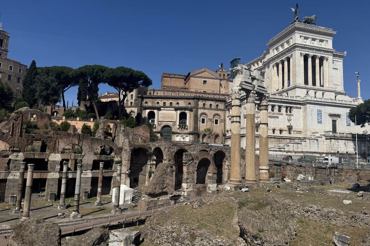 View of ancient Roman ruins with the Vittoriano monument in Rome