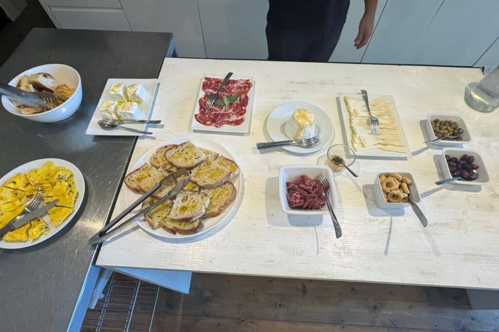 Italian lunch featuring bread, olive oil, cheeses, cured meats and olives