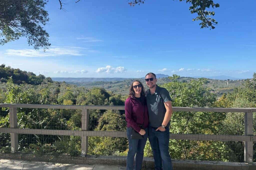 Two visitors overlooking the green hills of the Sabina countryside in Italy at an olive oil tour from Rome
